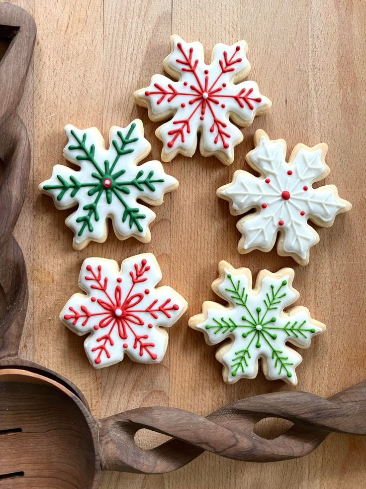 cookies decorated with icing and snowflakes are on a table in front of the words, cookie artistia winter wonderland cookies