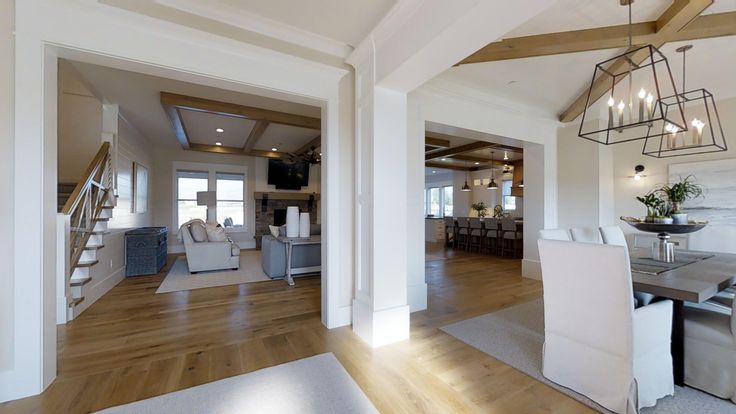 a dining room and living room with wood flooring in an open concept style home