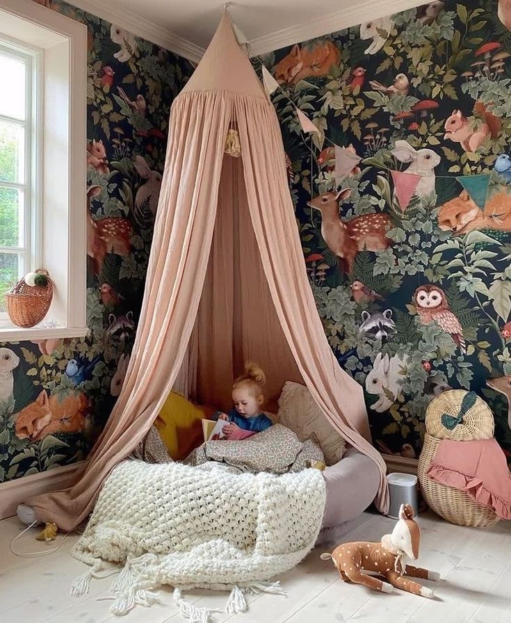 a child's bedroom with floral wallpaper and pink canopy over the crib