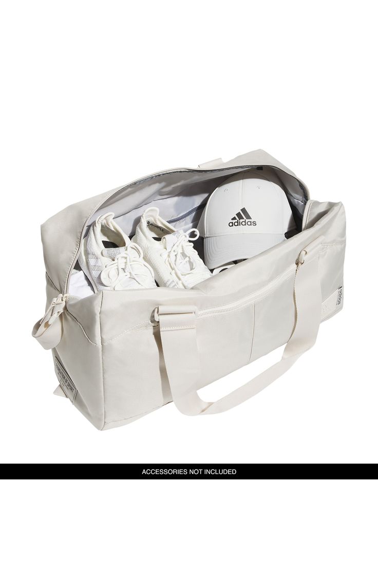 Tonal hardware and subtle branding distinguish a duffle bag that's designed with an internal shoe comaprtment and an external  trolley strap for easy carrying. 11"H x 10"W x 19.75"L Interior zip compartment Exterior trolley strap Polyester Imported Functional Adidas Bags For On-the-go, Functional White Travel Bag With Adjustable Strap, Rectangular Adidas Bag For Everyday Use, Adidas Rectangular Bag For Everyday Use, Adidas Shoulder Bag With Adjustable Strap For Travel, White Duffle Bag For Overnight Trips With Zipper, White Duffle Bag For Overnight Trips With Zipper Closure, Functional White Tote Duffle Bag, Functional White Duffle Bag