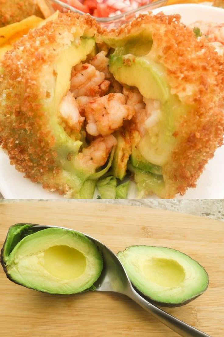 an avocado is cut in half and placed on a cutting board with a spoon