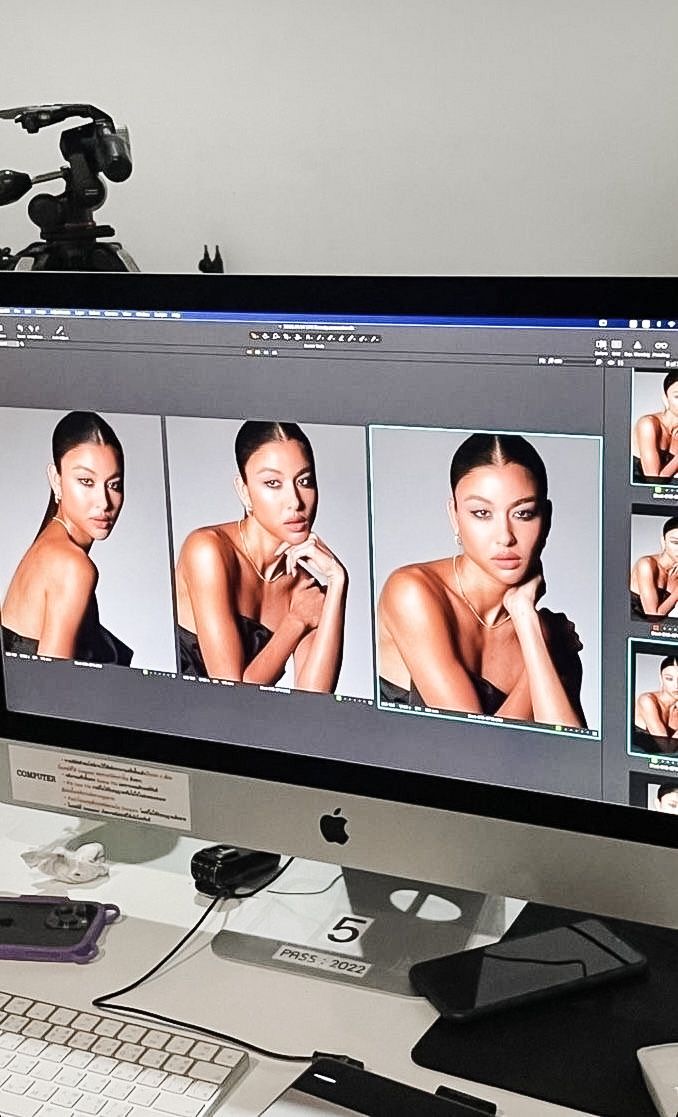 a computer screen with multiple images of women on it and a camera attached to the monitor