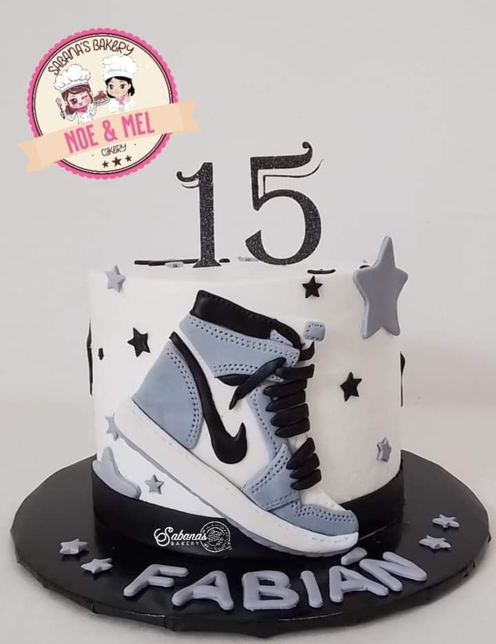 a white and black birthday cake with a shoe on it's top that says 15