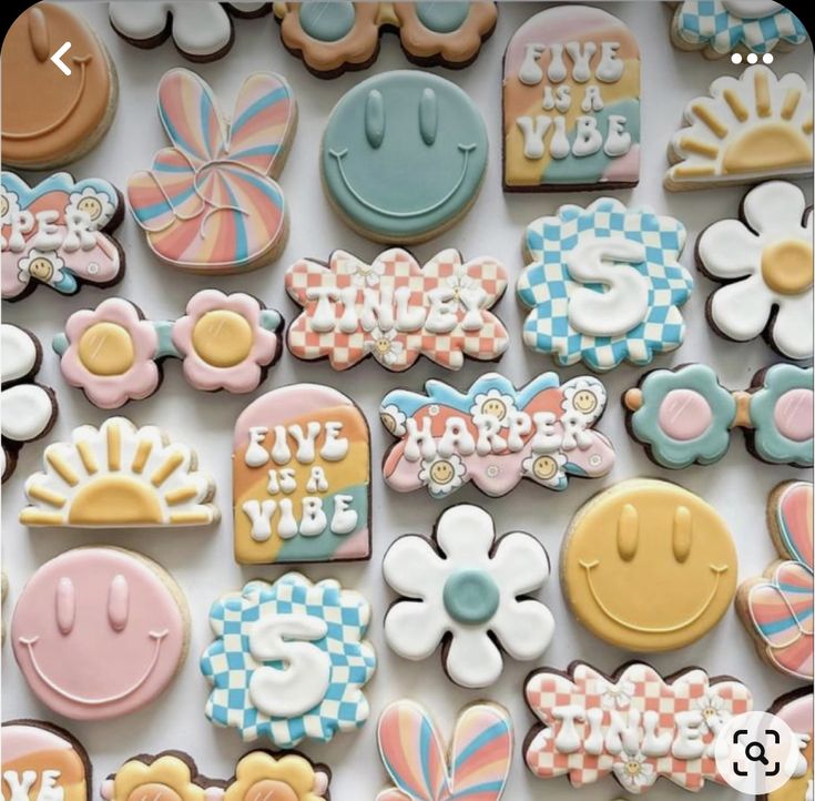 many decorated cookies are displayed on a table