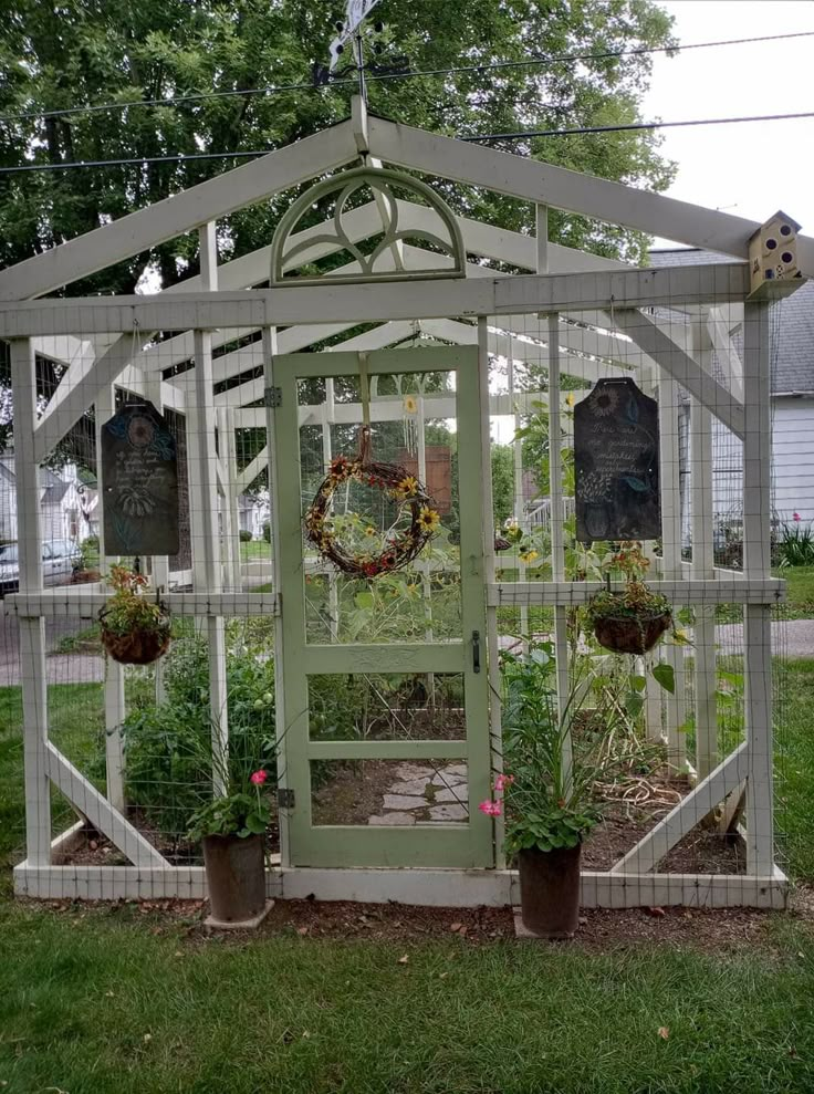 a small greenhouse with potted plants in it