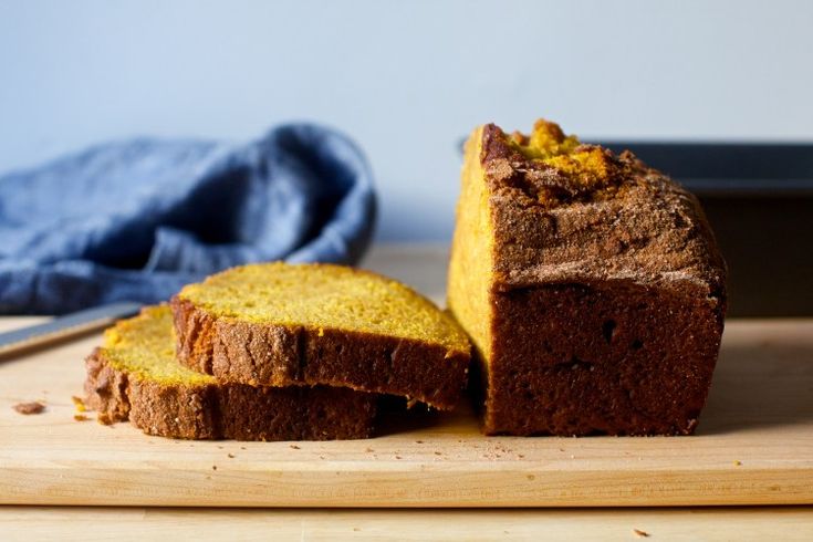 a loaf of bread sitting on top of a wooden cutting board