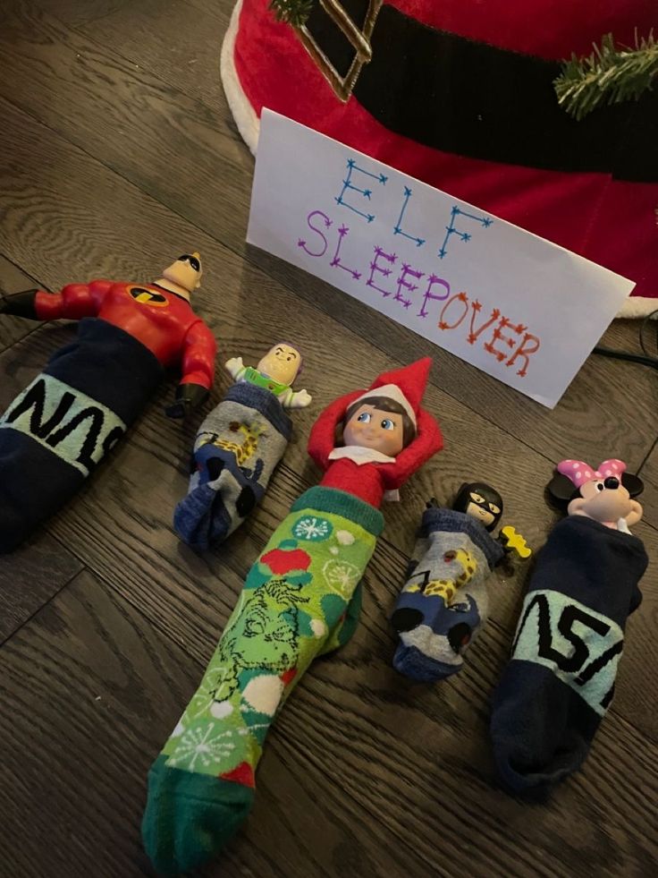 elf slippers are lined up on the floor next to a sign that says elf sleepover