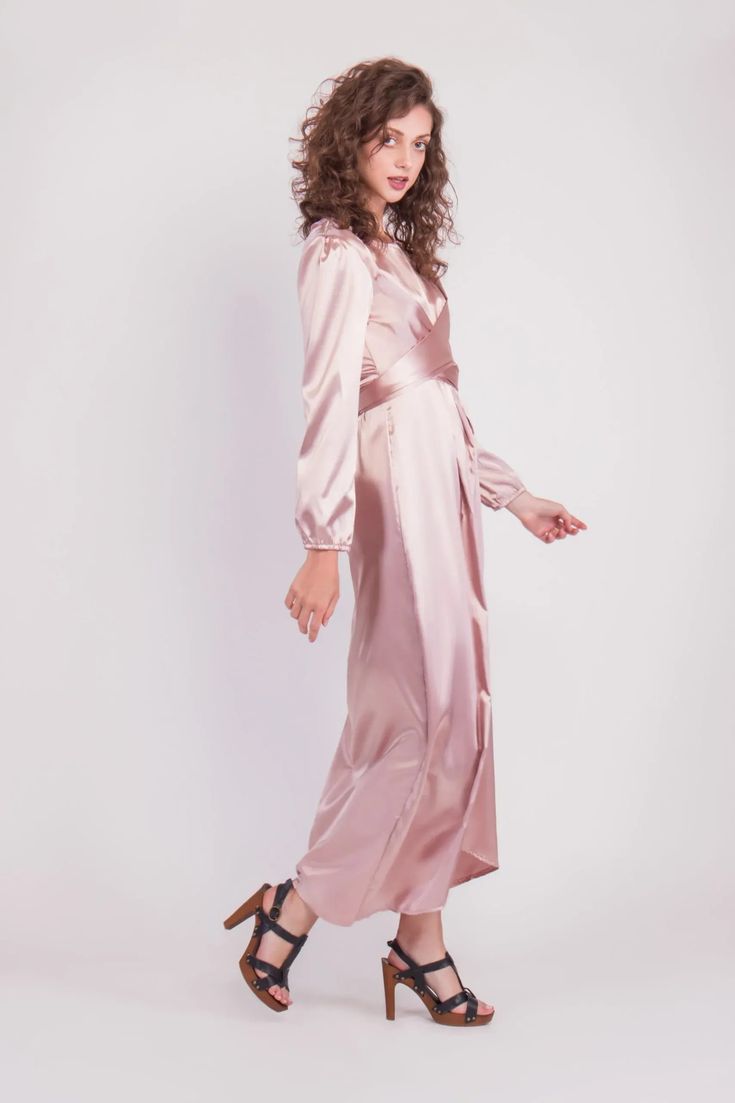 Feel more confident than ever before in the Satin Wrap Maxi Dress with Puff Sleeves that combines modesty with today’s most current modest fashion trends. The sleek satin maxi dress accentuates the waist with a luxurious wrap design while the puff sleeves accent a bold shoulder and feminine shape.Perfect for every special occasion, the unique dress comes in multiple colors to best fit your individual personality. Satin Belted Midi Dress For Party, Party Satin Midi Dress With Belt, Satin Maxi Dress With Tie Waist, Satin Maxi Dress With Side Slits, Elegant Satin Belted Maxi Dress, Elegant Belted Satin Maxi Dress, Formal Maxi Dress With Belt, Elegant Maxi Length Belted Dress For Party, Belted Maxi Length Evening Dresses