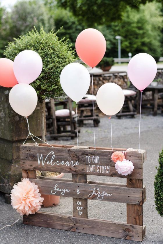 some balloons are in the air near a wooden box