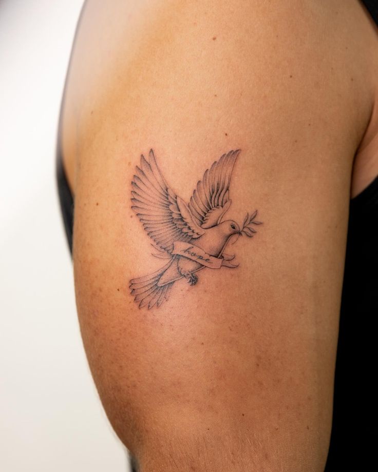 a woman's arm with a tattoo of a bird on the left side of her body