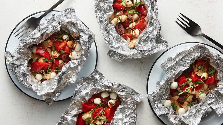 four plates with food on them and forks