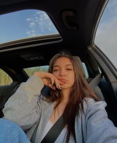 a woman sitting in the back seat of a car