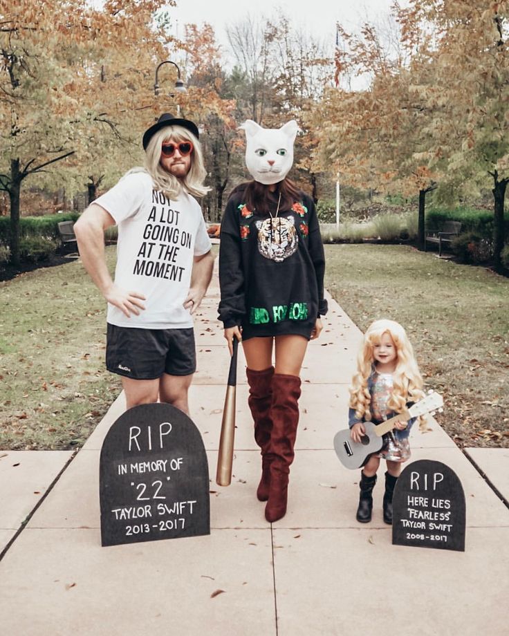 two people in costumes standing on a sidewalk