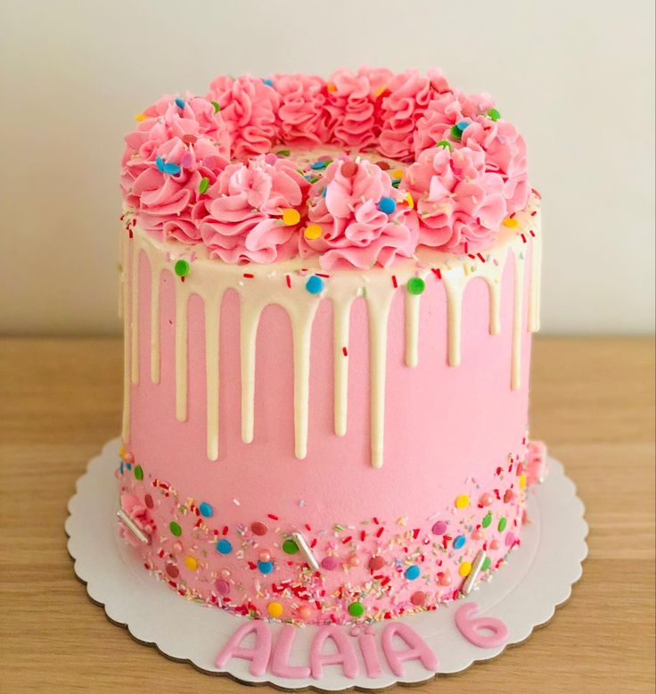 a birthday cake with pink frosting and sprinkles