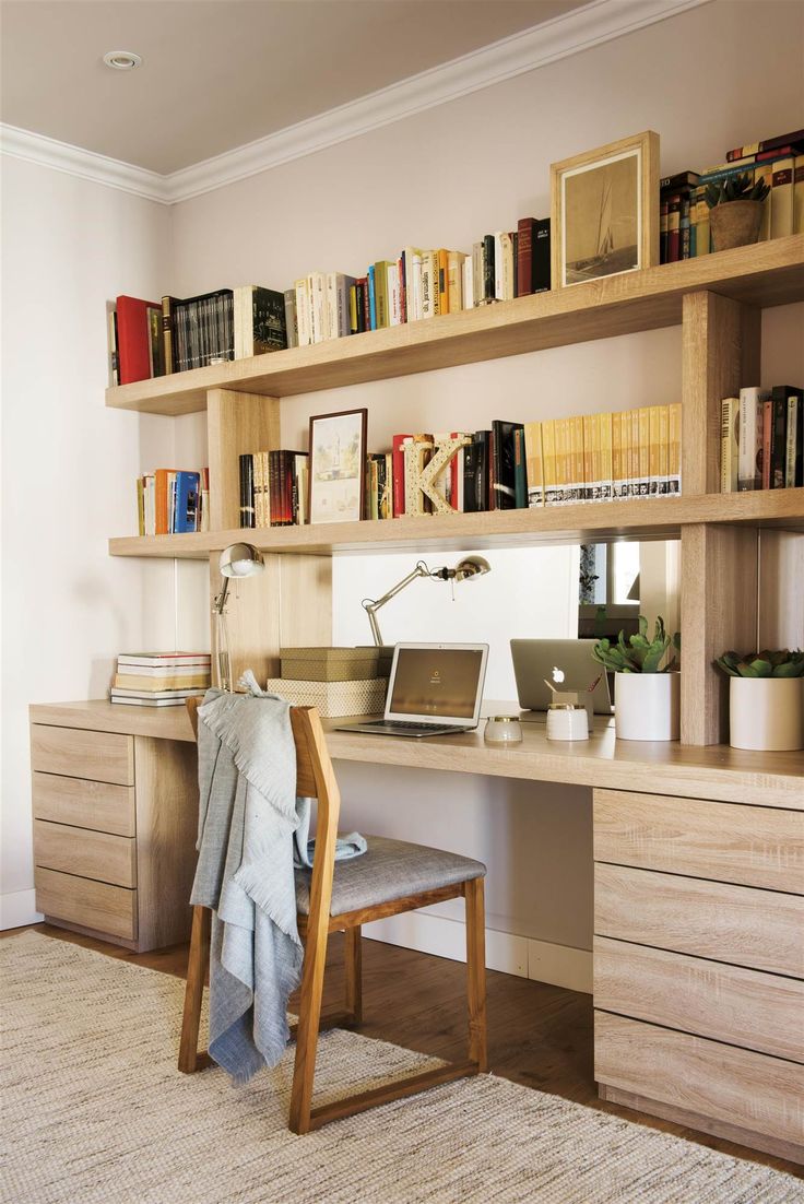 a home office with bookshelves, desk and chair