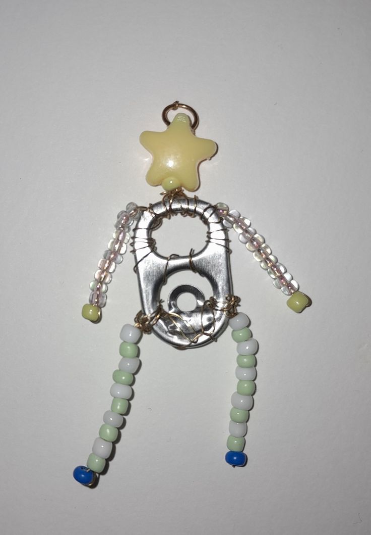 a metal object with beads and a star on it's back end, attached to a wall