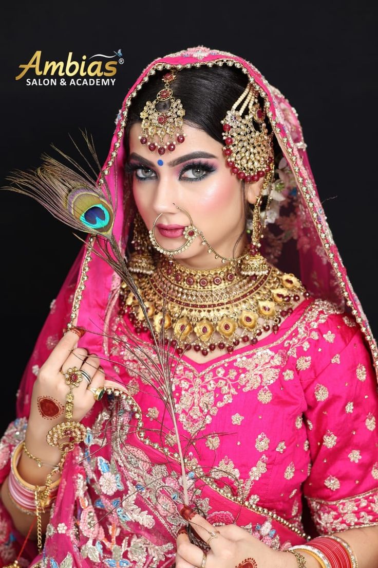 a woman in a pink and gold bridal outfit