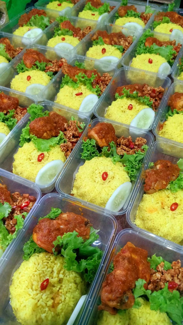 many plastic containers filled with food on top of a table next to other trays