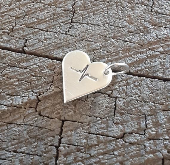 Tiny and dainty solid sterling silver heart charm for Nurses , EMT's , CNA's , Doctors and all other healthcare workersshow your appreciation with this small giftsmall heart beat was stamped by hand into the metal measurements : 1/2 inch in size with a thickness of 1 mm ( 18 gauge ) Hypoallergenic Pendant Charms For Gifts, Hypoallergenic Pendant Charm As A Gift, Personalized Sterling Silver Charms For Gifts, Small Hypoallergenic Sterling Silver Charm Necklaces, Personalized Sterling Silver Charms For Valentine's Day, Small Hypoallergenic Sterling Silver Charm Necklace, Silver Heart Pendant Charms For Mother's Day, Hand Stamped Heart Sterling Silver Charm Necklace, Sterling Silver Heart Charm Necklace