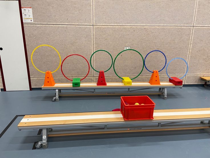 two benches with different colored plastic objects on them