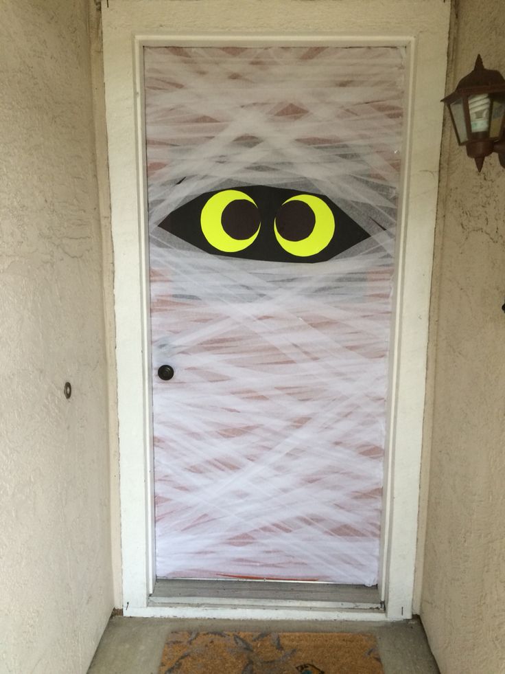 a door decorated with yarn and eyes