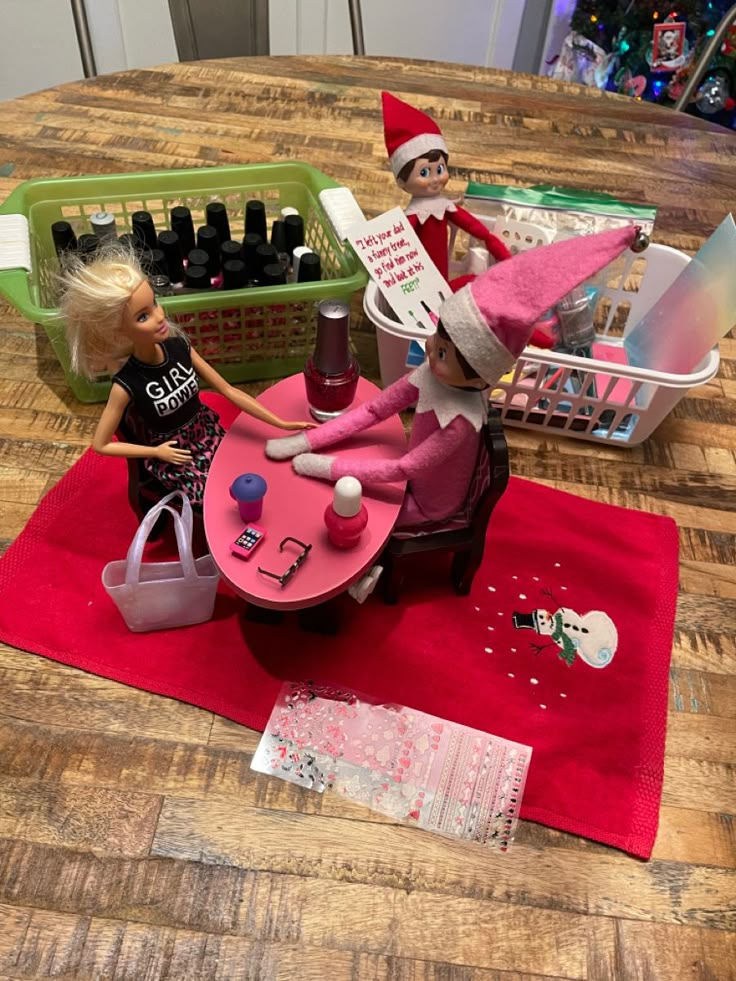 two elfs are sitting on a table with bottles and other items in the background