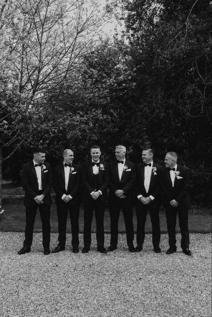 a group of men in tuxedos standing next to each other