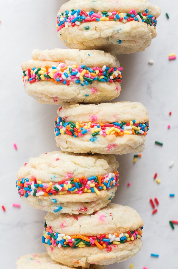 sprinkled cookies stacked on top of each other with colorful sprinkles