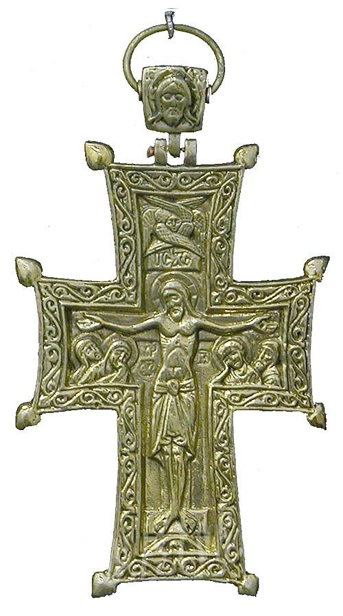 an ornate metal cross with jesus on it