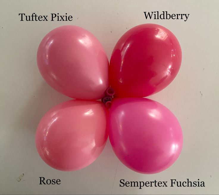 four pink balloons arranged in the shape of flowers