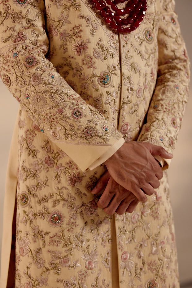 a man in a white suit and red tie standing with his hands on his chest