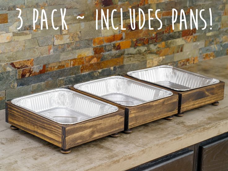 three aluminum pans sitting on top of a counter next to a brick wall with the words, 3 pack - includes pans