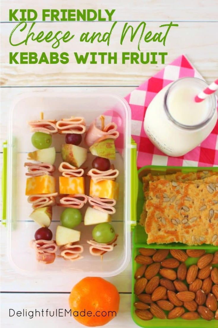 kid friendly cheese and meat kebabs with fruit on the side, next to a glass of milk