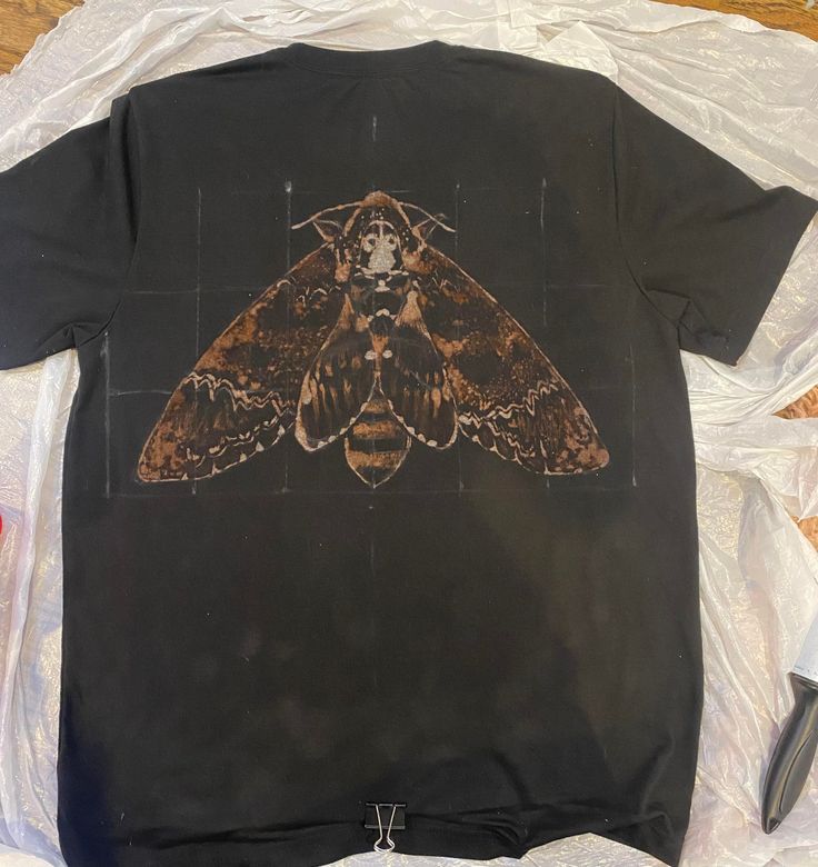 I hand paint these shirts  with custom nature-themed bleach designs. Commissions are open - just put the info in the personalization textbox. Pick a species of animal, plant ,fish, bug, etc. for the shirt design. Main designs can be painted on the front of the shirt or on the back with a small design on the front. The shirts  are a cotton/polyester blend and come in unisex sizes S through 3X. Please message me with any questions! Bleached Ribcage Shirt, Moon Bleach Shirt, Bleach Jumper Design, Cool Designs For Shirts, Bleaching T Shirt, Bleached T Shirt Designs, Bleach Pattern Shirt, Bleach Painted T Shirt, Bleach T Shirt Designs