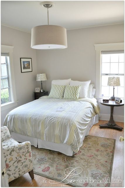 a bedroom with a bed, chair and lamp in it's centerpieces