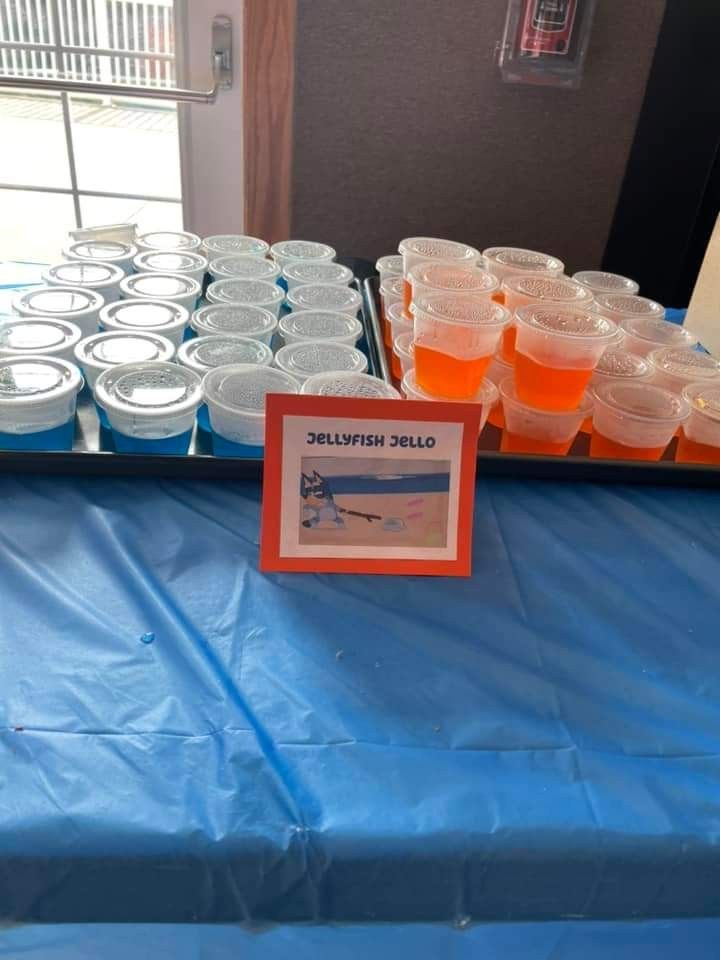 there are many cups on the table with orange liquid in them and one is empty