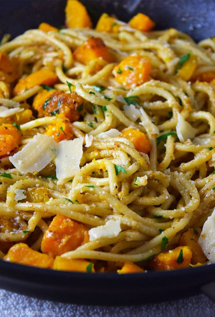 pasta with buttered squash and parmesan cheese in a skillet on a table