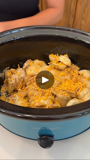 a slow cooker filled with food sitting on top of a table