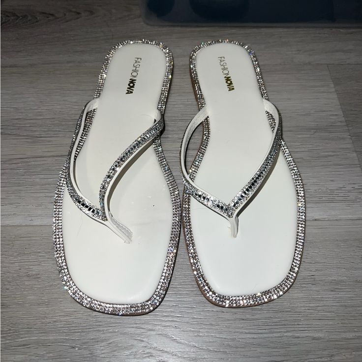 Fashion Nova Flip Flops With Gems Size 9 Never Worn White Synthetic Sandals With Single Toe Strap, Trendy White Toe Post Sandals, White Synthetic Flip Flops With Single Toe Strap, White Single Toe Strap Flip Flops For Spring, White Synthetic Single Toe Strap Flip Flops, White Synthetic Toe Post Flip Flops, White Synthetic Flat Flip Flops, White Open Toe Flip Flops For Party, White Synthetic Party Flip Flops