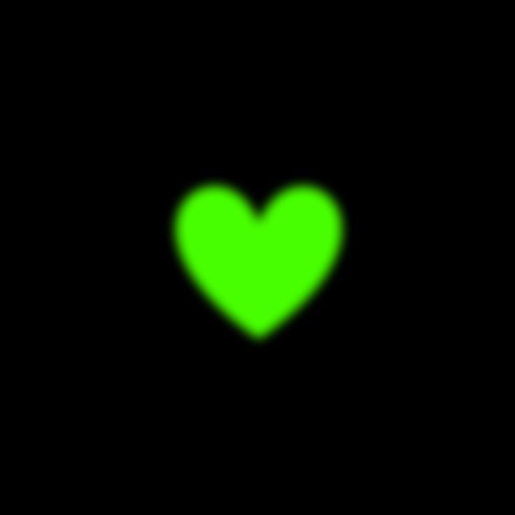 a green heart on a black background in the middle of the image is an object that appears to be blurry