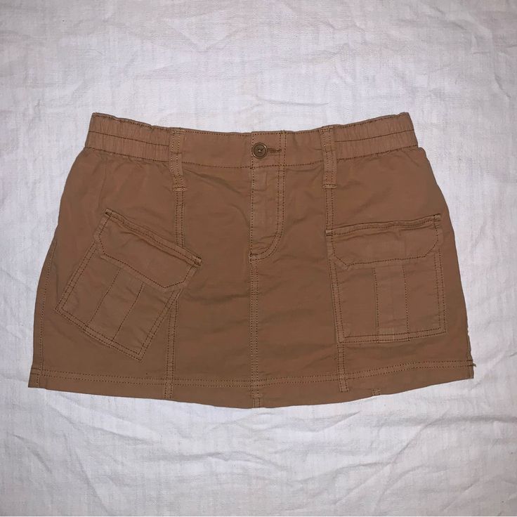 Khaki / Tan / Brown Cargo Skirt With Pockets Flattering And Comfortable Fit Excellent Condition- Never Worn! Brown Cotton Mini Skirt With Pockets, Casual Brown Skort With Pockets, Brown Cargo Skirt With Pockets For Spring, Casual Beige Mini Skirt With Pockets, Relaxed Fit Brown Cotton Skirt, High Waist Brown Skort With Pockets, Trendy Brown Skort With Pockets, High Waist Brown Skirt With Pockets, Brown Mini Skort With Pockets