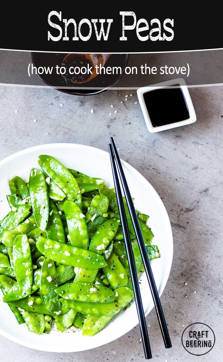 a white plate topped with green beans and chopsticks