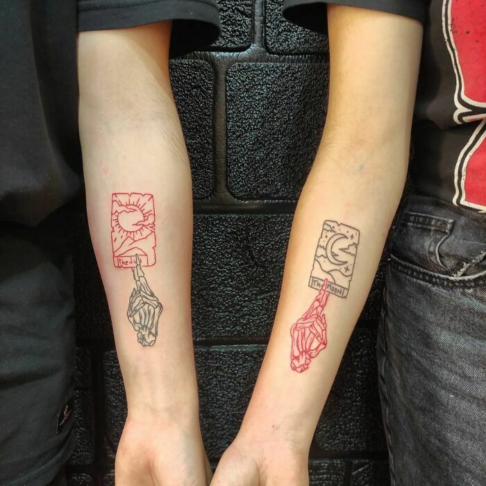 two people with matching tattoos on their arms