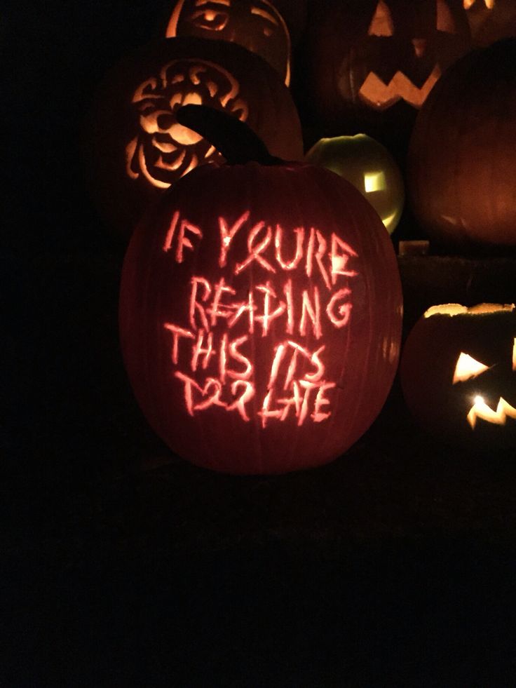 carved pumpkins with words written on them