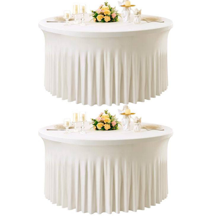 two tiered tables with flowers and candles on them