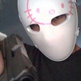 a person wearing a white hello kitty mask