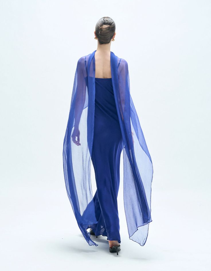 Step into elegance with this floor length slip dress, crafted from luxurious modal satin, perfect for cocktail parties or sundowner events. The holy-grail silhouette, paired with a timeless color palette, offers a sophisticated and flattering look. Its graceful cowl neckline with adjustable shoulder straps suits every body type, providing the perfect boost of confidence for any occasion. Chic Blue Draped Evening Dress, Elegant Blue Silk Kaftan, Elegant Blue Draped Maxi Dress, Blue Fitted Floor-length Slip Dress, Elegant Blue Floor-length Kaftan, Timeless Color Palette, Cocktail Parties, Cowl Neckline, Holy Grail