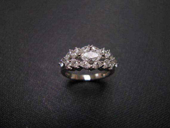 a diamond ring sitting on top of a black surface