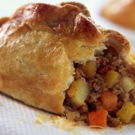 a close up of a pastry with meat and vegetables