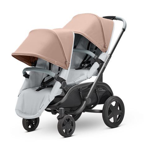 two baby strollers with beige and white covers on the sides, facing each other